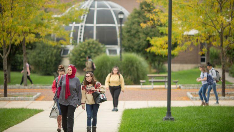 Image shows students walking on the Main Campus mall area.
